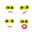 Four funny faces - eyes and mouths - made of multicolored plasticine with different expressions on the white background.