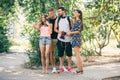 Four funny friends taking selfie with a smart phone in park Royalty Free Stock Photo