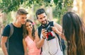 Four funny friends taking selfie with a smart phone in park Royalty Free Stock Photo