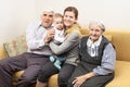 Four generation family sitting on sofa