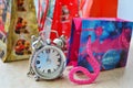 Four gift bags and a clock Royalty Free Stock Photo