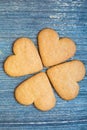 Four ginger bread biscuit on aged grey wooden surface. Postcard for saint valentines day background. Four-leaf clover