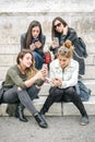 Four girl friends happy watching internet social media in smartphone Royalty Free Stock Photo