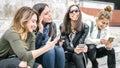 Four girl friends happy watching internet social media in smartphone Royalty Free Stock Photo