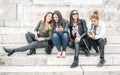 Four girl friends happy watching internet social media in smartphone