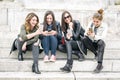 Four girl friends happy watching internet social media in smartphone