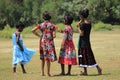 Four girls with colorful dresses.