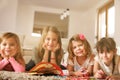 Four girls lying on the floor. Royalty Free Stock Photo