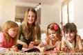 Four girls lying on the floor. Royalty Free Stock Photo