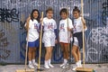 Four girls participating in community cleanup