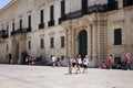 Four girls walk in front of Palace Armoury