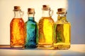 Four glass bottles with different colored versions of vegetable oils