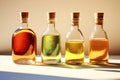 Four glass bottles with different colored versions of vegetable oils. Transparent vessels with cork stoppers in beautiful bright Royalty Free Stock Photo