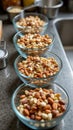 Four glass bowls filled with mixed nuts in a kitchen setting Royalty Free Stock Photo