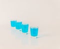 Four glasses of blue kamikaze, glamorous drink, mixed drink pour Royalty Free Stock Photo