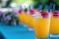 Four glasses of orange juice garnished with fresh strawberries sit on a table. Royalty Free Stock Photo