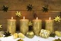 Four golden burning christmas candles for advent decoration. Royalty Free Stock Photo