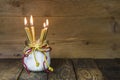 Four golden candles, traditional christmas decoration on a woo