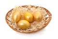 Four golden eggs in a basket Royalty Free Stock Photo