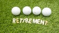 Four golf ball are on green grass with Retirement word