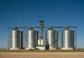 Four Grain Elevators Stand Tall Against Blue Sky