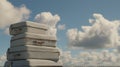 Four gray suitcases are stacked against a backdrop of a blue sky with fluffy white clouds Royalty Free Stock Photo