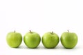 Four green apples in a row Royalty Free Stock Photo