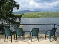 Four Green Chairs Overlooking a Lake