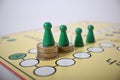 Game board green figures on money pile