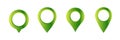 Set of four green location markers with white centers for maps and navigation interfaces