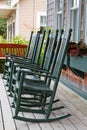 Four green rocking chairs