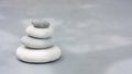 Four grey roundstones on clear gray background. Spa stones, zen like concept. Pastel colors Royalty Free Stock Photo