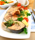 Four Grilled salmon steak with vegetables on white plate Royalty Free Stock Photo