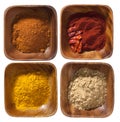 Four ground up spices in wooden bowels Royalty Free Stock Photo