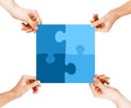 Four hands connecting puzzle pieces Royalty Free Stock Photo