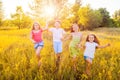 Four happy beautiful children running playing moving together in the beautiful summer day. Royalty Free Stock Photo