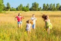 Four happy beautiful children running playing moving together in the beautiful summer day. Royalty Free Stock Photo