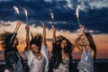 Four happy female friends with sparklers