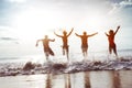 Four happy friends runs to sunset beach Royalty Free Stock Photo