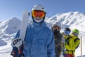 Four happy friends snowboarders and skiers are having fun on ski slope with ski and snowboards in sunny day Royalty Free Stock Photo