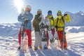 Four happy friends snowboarders and skiers are having fun on ski slope with ski and snowboards in sunny day Royalty Free Stock Photo