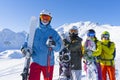 Four happy friends snowboarders and skiers are having fun on ski slope with ski and snowboards in sunny day. Royalty Free Stock Photo