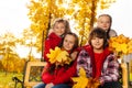 Four happy kids with maple bouquet Royalty Free Stock Photo