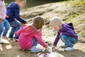 Four happy kids playing by a river Royalty Free Stock Photo