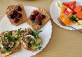 Four healthy sandwiches with dark wholemeal bread. One serving of fresh vegetables Royalty Free Stock Photo