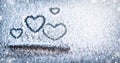 Four hearts symbol of love hand drawing painted on snow on the glass above windshield wiper of a car. Valentine`s Day, love.