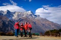 Four hikers in red winter jacket are doing selfie in Everest Base Camp trek with blue sky and himalayan mountain range at the