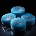 Four hockey pucks made of cerulean blue concrete on black background generative AI