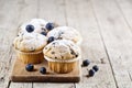 Four homemade fresh muffins with blueberries on rustic wooden table background Royalty Free Stock Photo