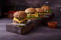 Four homemade hamburgers on wooden table